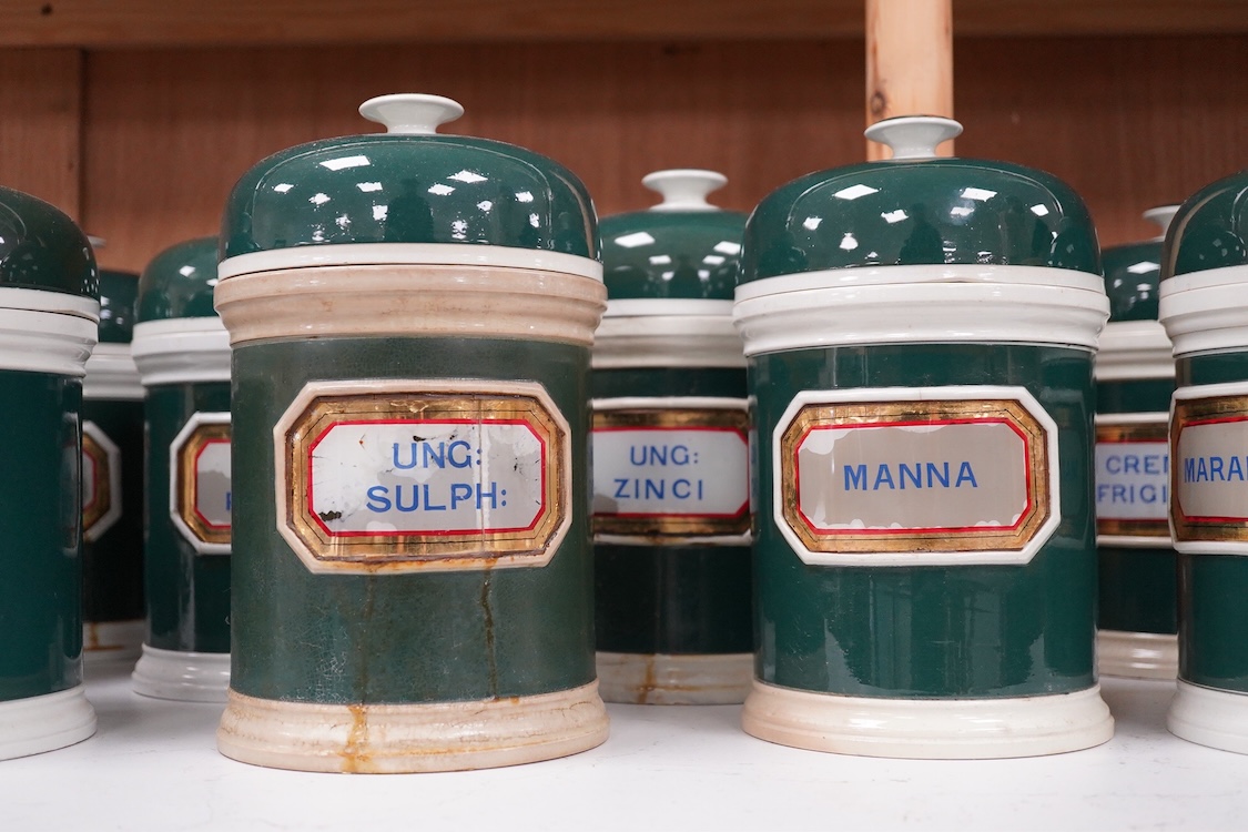 A collection of sixteen 19th/early 20th century ceramic lidded green apothecary jars, with labels painted within panels with raised ceramic edges and gilt lined, examples including; Ung: Zinci, Ung: Sulphur:, Mel: Boraci